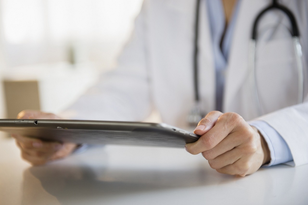 A doctor holding a tablet